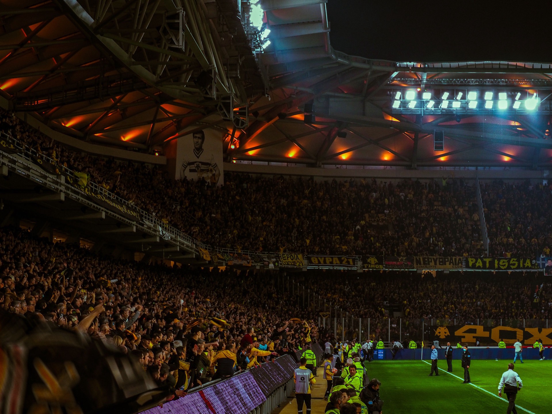 Sports fans cheering in a packed stadium